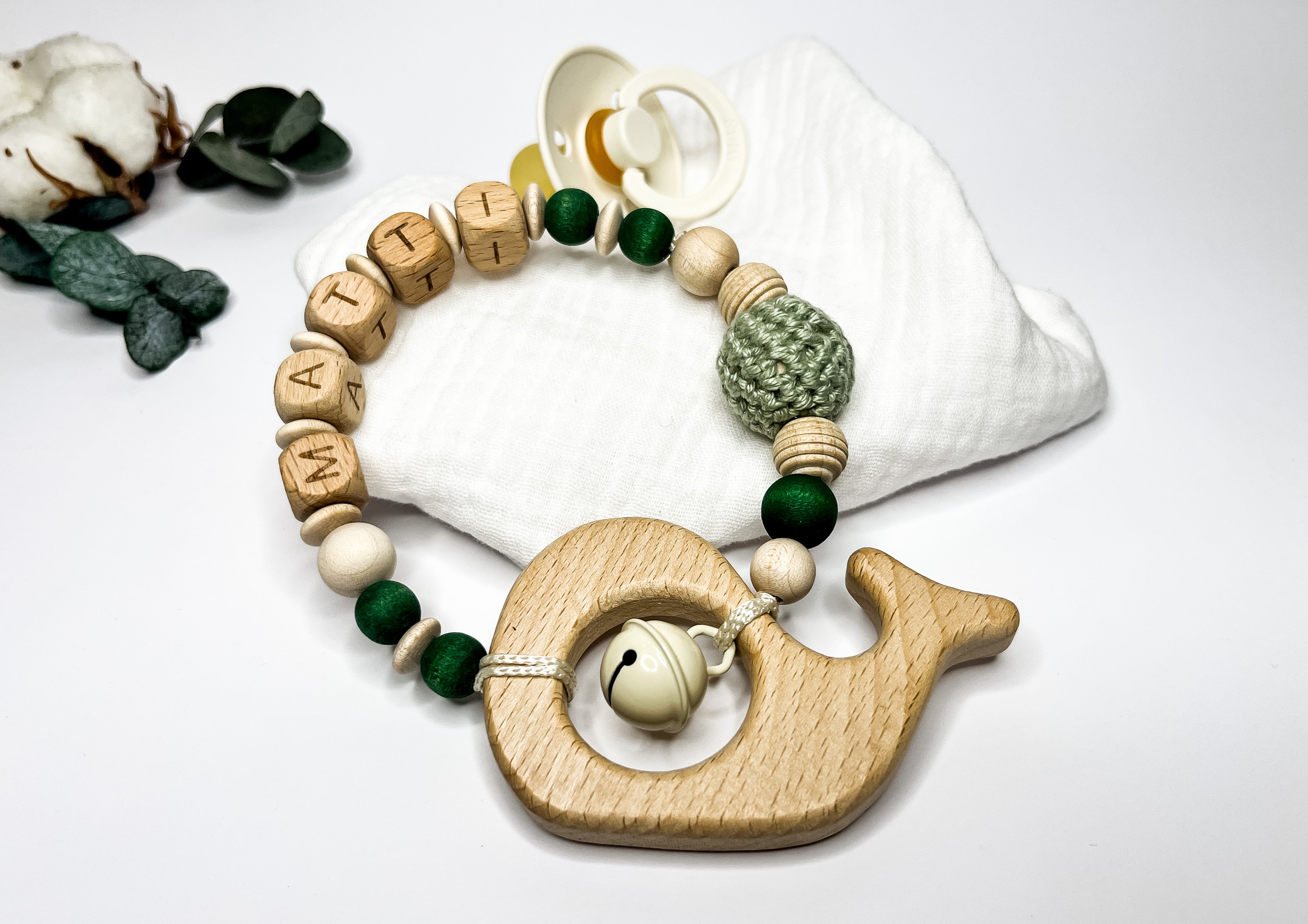 Greifring und Beißring aus Holz für Babys, geeignet zum Greifen und Kauen während der Babyzeit.